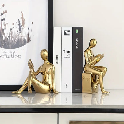 Abstrakte statuer af siddende figurer med blank keramisk finish
