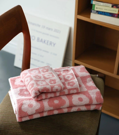 Badehåndklæde i bomuld og polyester med elegant blomstermønster