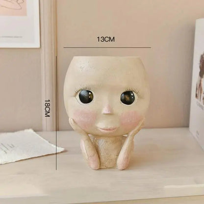 Elegant ansigtsplantekrukke i resin med kunstneriske detaljer