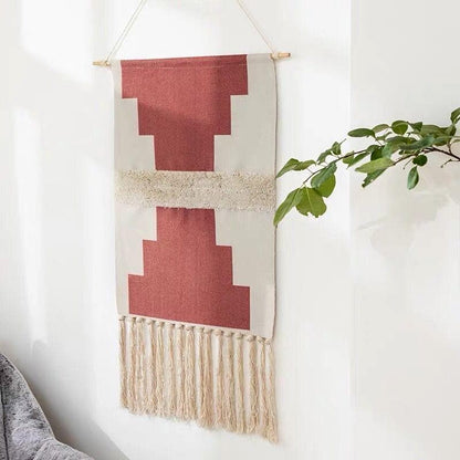 Håndvævet vægtæppe i bomuld med geometrisk design og kvastdetalje